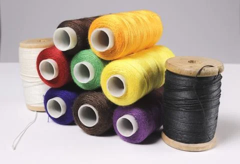 A set of spools of colored sewing threads. Stock Photos