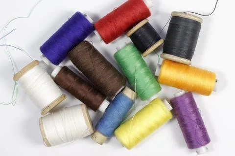 A set of spools of colored sewing threads. Stock Photos