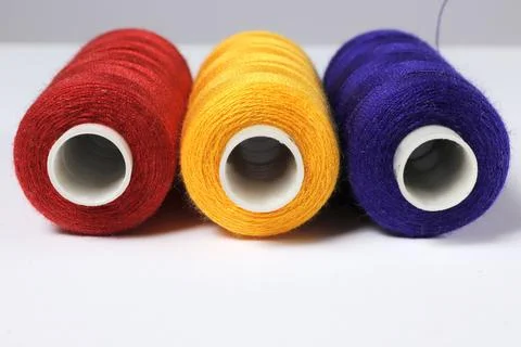 A set of spools of colored sewing threads. Stock Photos