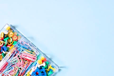 A set of stationery made of multi-colored buttons and paper clips in a box on Stock Photos