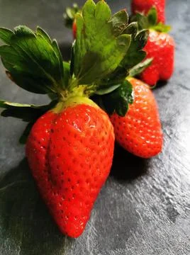 Set of strawberries on the kitchen bench Stock Photos