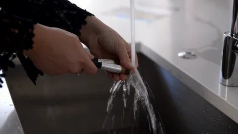 ON SET STYLIST WASHES MAKEUP BRUSHES IN SINK Stock Footage 111345586