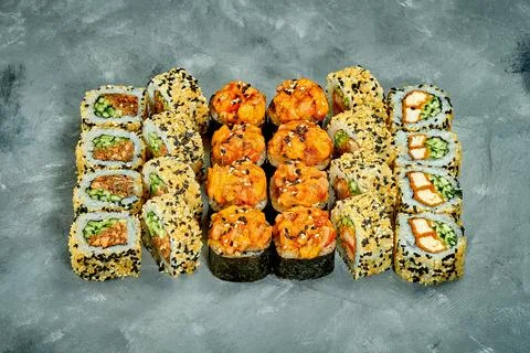 Set of sushi rolls with different fillings on a gray background. Selective Fo Stock Photos