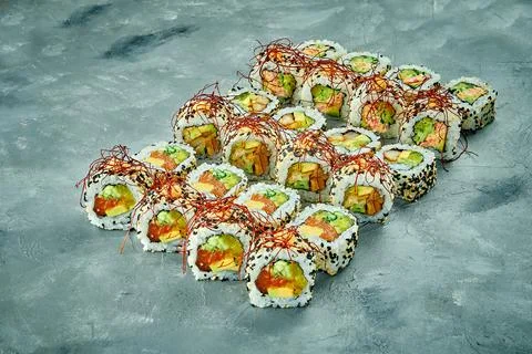 Set of sushi rolls with different fillings on a gray background. Selective Fo Stock Photos