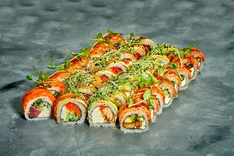 Set of sushi rolls with different fillings on a gray background. Selective Fo Stock Photos