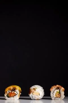 Set of sushi rolls isolated on black background Stock Photos