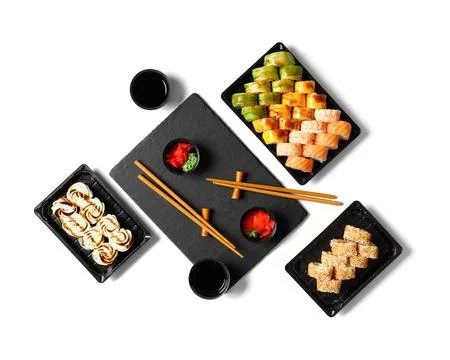 Set of sushi rolls in plastic packages on a white background, top view. Stock Photos