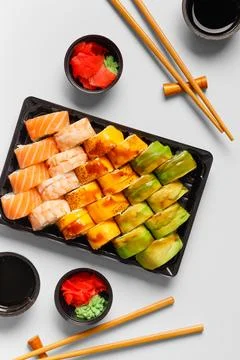 Set of sushi rolls in plastic packages on a white background, top view. Stock Photos