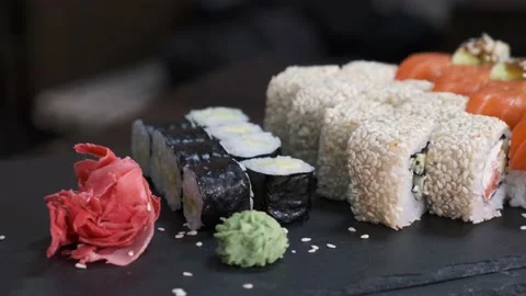 Set of Sushi Rolls on rotating table on black Background close-up. Video stock 139517109