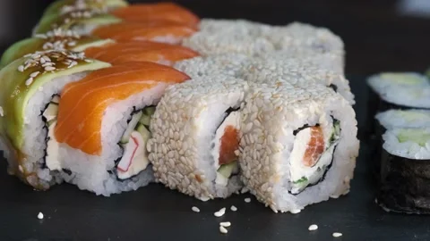 Set of Sushi Rolls on rotating table on black Background close-up. Stock Footage 139517313