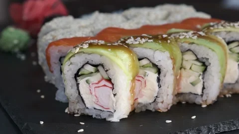 Set of Sushi Rolls on rotating table on black Background close-up. Video stock 139517638