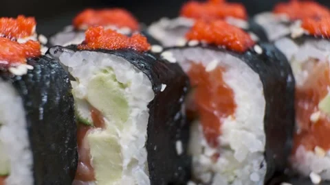 Set of Sushi Rolls on rotating table on black Background close-up. Stock Footage 139517951