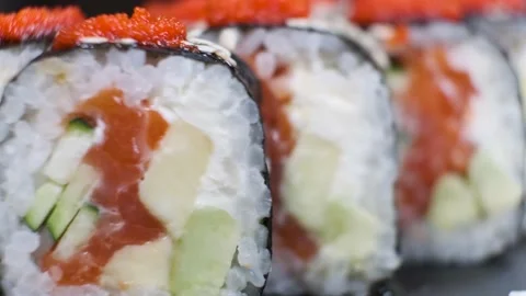 Set of Sushi Rolls on rotating table on black Background close-up. Video stock 139626068