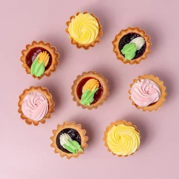 Set of sweet cakes on pink backdrop Stock Photos