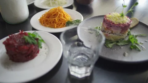 Set table with gourmet high kitchen dinner plates and dishes at the restaurant Stock Footage 303554774