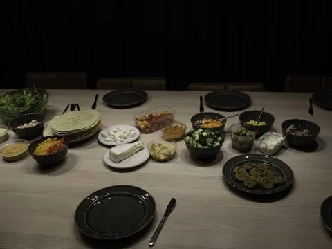 Set table for lunch with various ingredients for salad Stock Photos