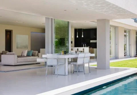 Set table on patio by pool of modern house Foto stock