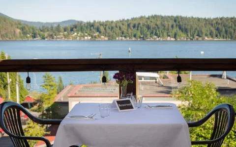A set table with a reserved sign and an ocean view overlooking Gibsons harbor. Stock Photos