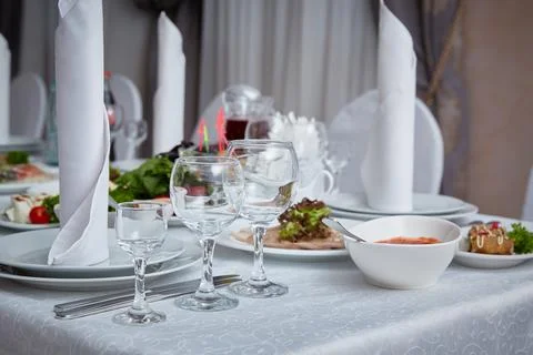 Set table in the restaurant with appliances and glasses Stock Photos
