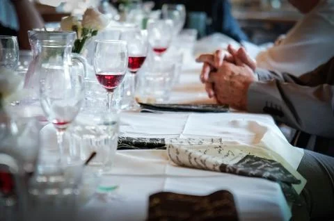Set table in a restaurant with hands in the foreground 写真素材