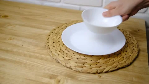 Set the table. Two plates, a spoon, and a fork were placed on the wooden table.  Video stock 147094593