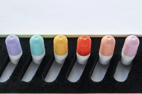 A set of tablets, vitamins in capsules lying in a special box Stock Photos