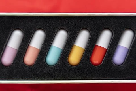 A set of tablets, vitamins in capsules lying in a special box Stock Photos