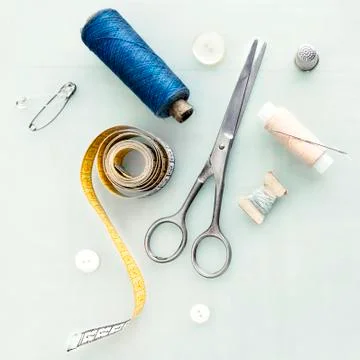 Set of tailoring tools and accessories on table, top view Photos