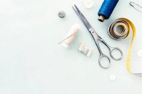 Set of tailoring tools and accessories on table, top view Photos