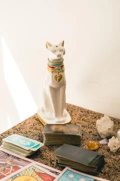 Set of a tarot reader on a table featuring various tarot decks, crystals, a.. Stock Photos