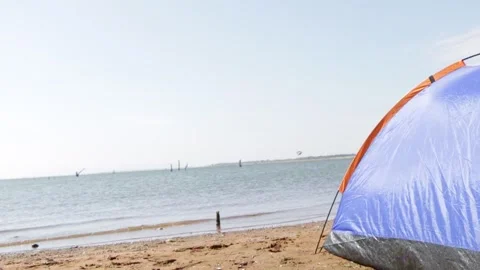 Set up a tent beside the beach with cool breezes. Stock Footage 137997837