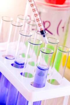 Set of test tubes with blue liquid on the desktop Stock Photos