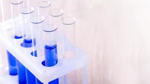 Set of test tubes with blue liquid on the desktop with copy space Stock Photos