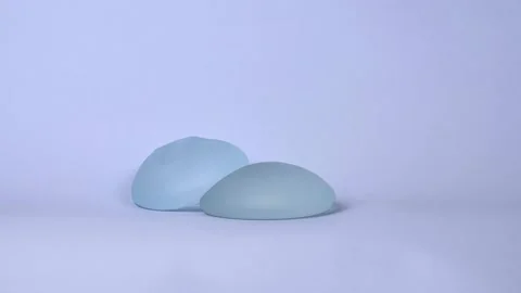 Set of textured breast implants on light blue background Stock-Footage 150560169