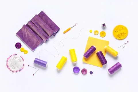 Set of thread spools with fabric and sewing supplies on white background Stock Photos