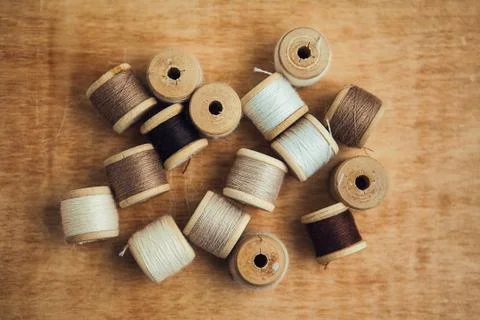 Set of thread on wooden background, flat lay Stock Photos