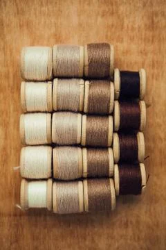 Set of thread on wooden background, flat lay Stock Photos