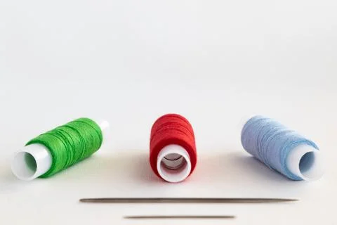 Set of threads and needles for sewing and copy space Stock Photos