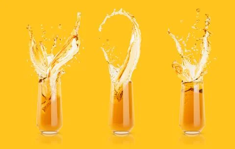 Set of three apple yellow cold juices in glass with bright splashes, drops fl Stock Photos