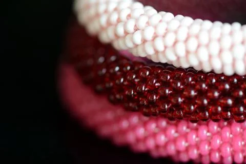 Set of three beaded bracelets on a dark background close up Stock Photos