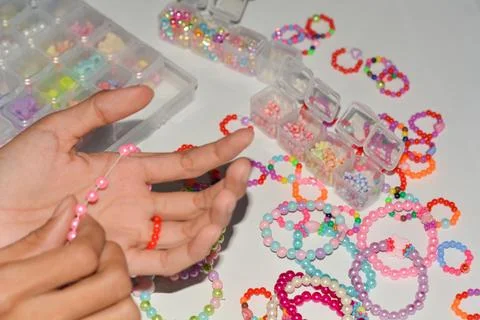 Set of three beaded children bracelets on a white background closeup Stock Photos