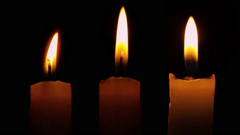 Set of three candles are burning on a black background. 4K ProRes 422, 30fps. Stock Footage 144249998