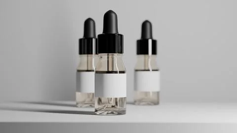 Set of three clear glass dropper bottles on white surface イラスト素材