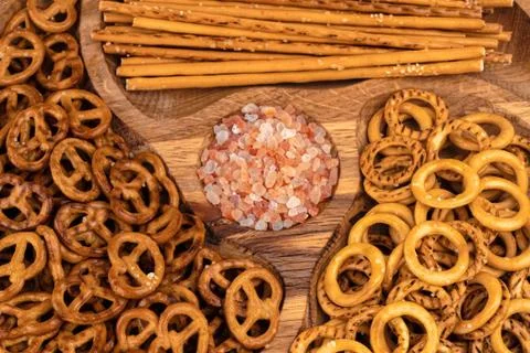 A set of three delicious beer snacks. On a beautiful wooden plate. Stock Photos
