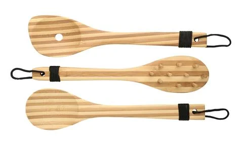 Set of three different bamboo spoons isolated on white background, close-up Stock Photos