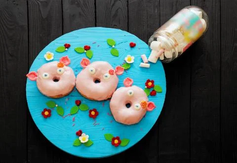 A set of three donuts in the form of pigs. sweets. glaze. delicious product Stock Photos