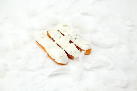 A set of three eclairs with white chocolate decor isolate on a white surface  Stock Photos
