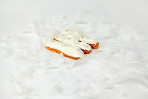 A set of three eclairs with white chocolate decor isolate on a white surface  Stock Photos