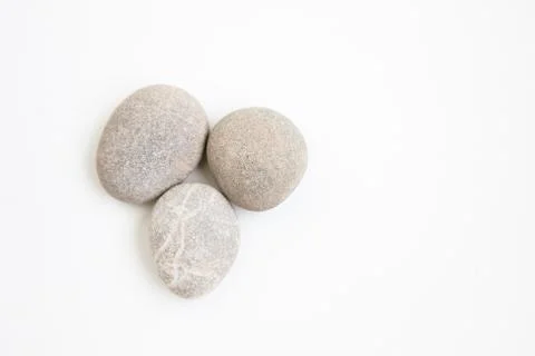 Set of three pebbles on the white background Stock Photos