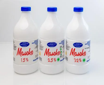 A set of three plastic milk bottles Fotos de archivo